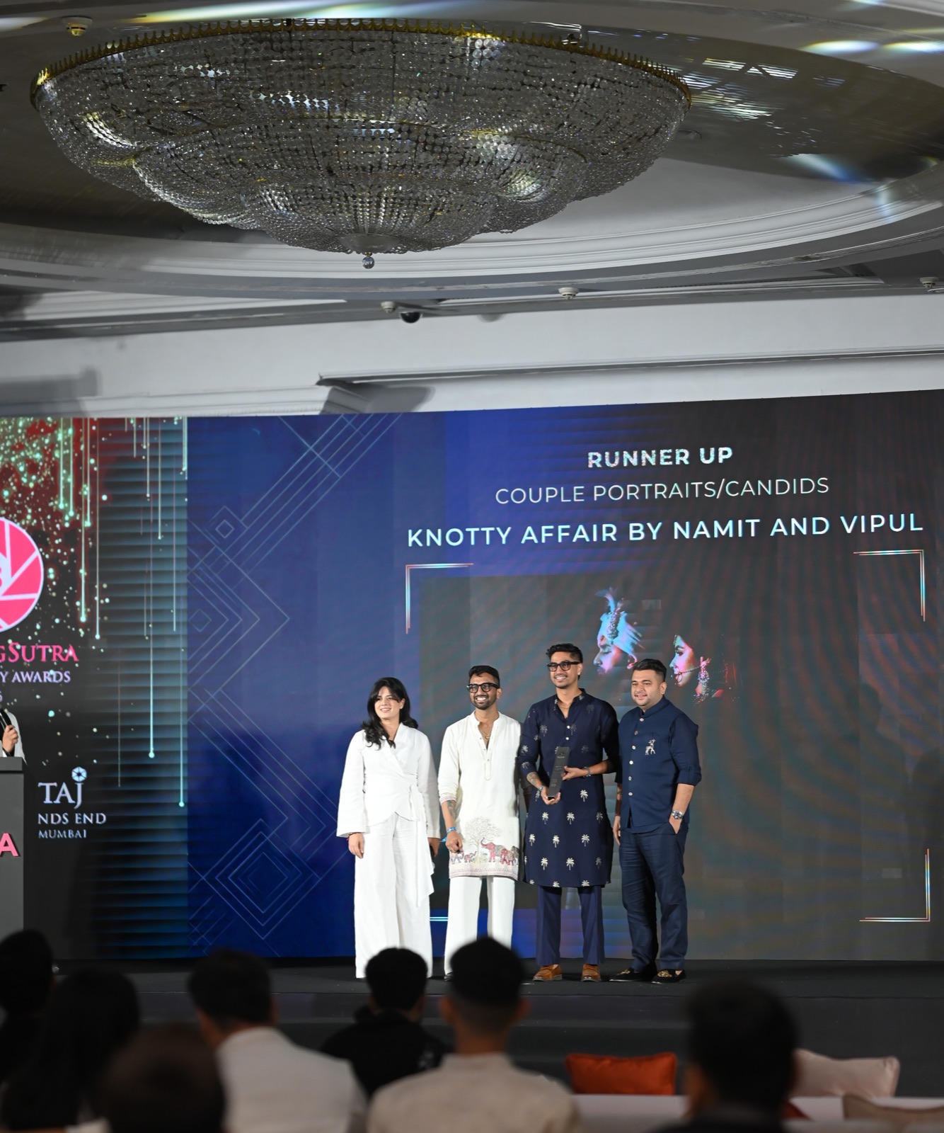 The Knotty Affair team on stage at a photography awards ceremony